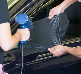 Car Wrap Being Placed on the Side Mirror