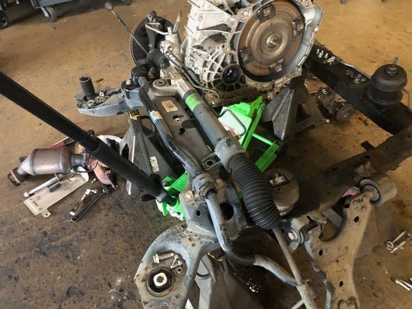 A car engine is being worked on in a garage