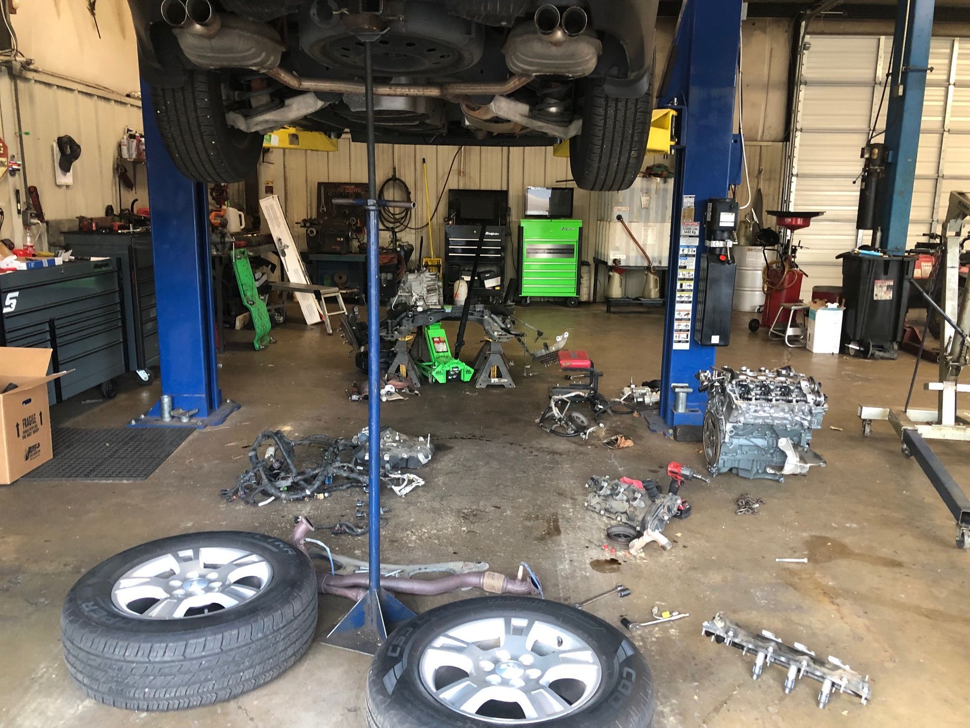 A car is being worked on in a garage.