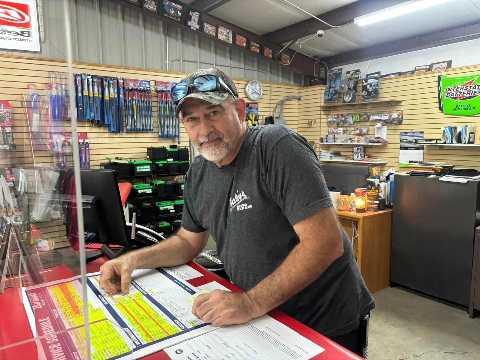 A man is sitting at a counter in a store.