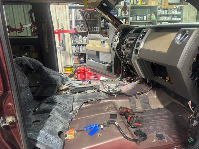 The interior of a truck is being worked on in a garage.