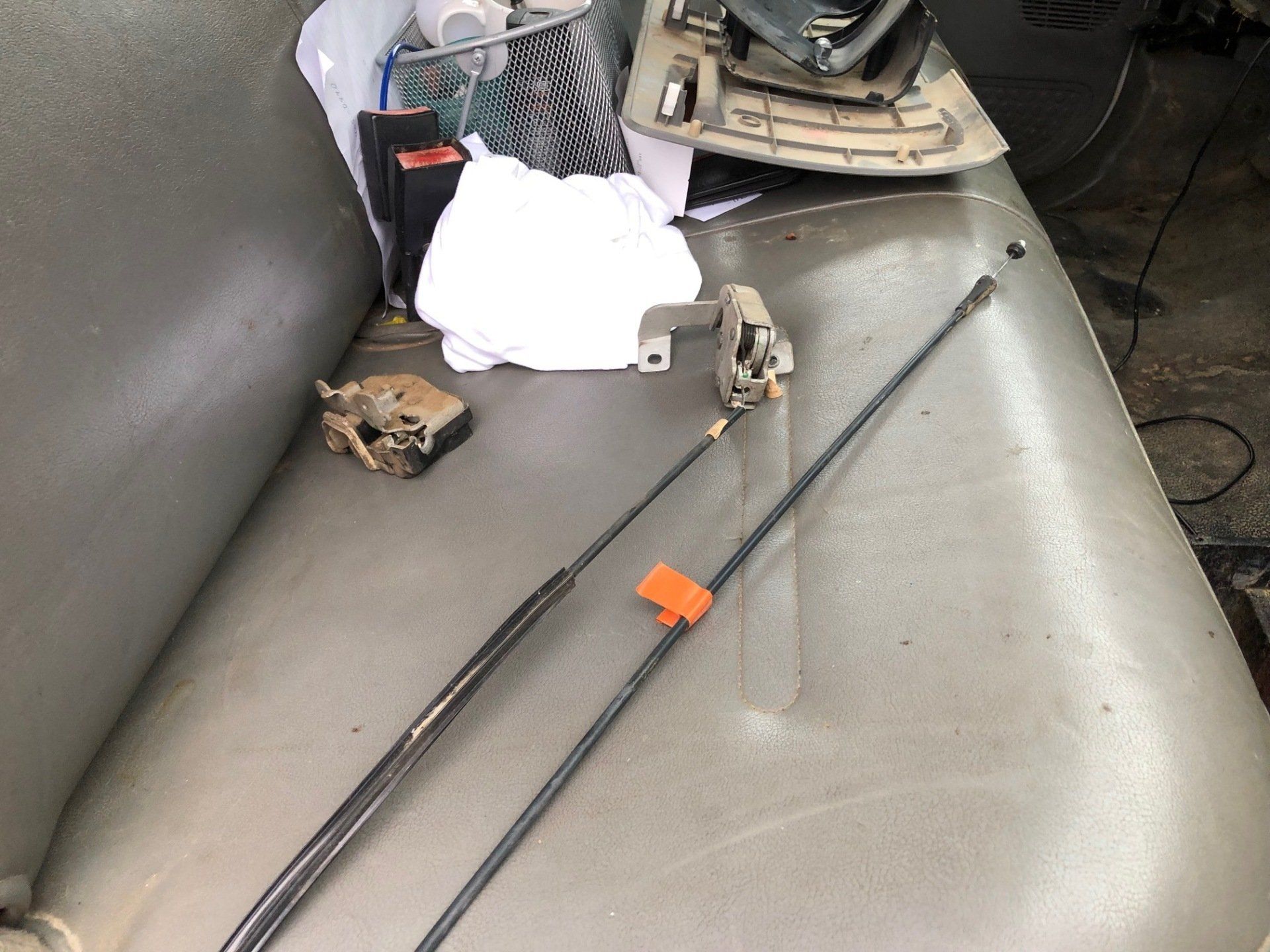 A gray couch with a bunch of tools on it