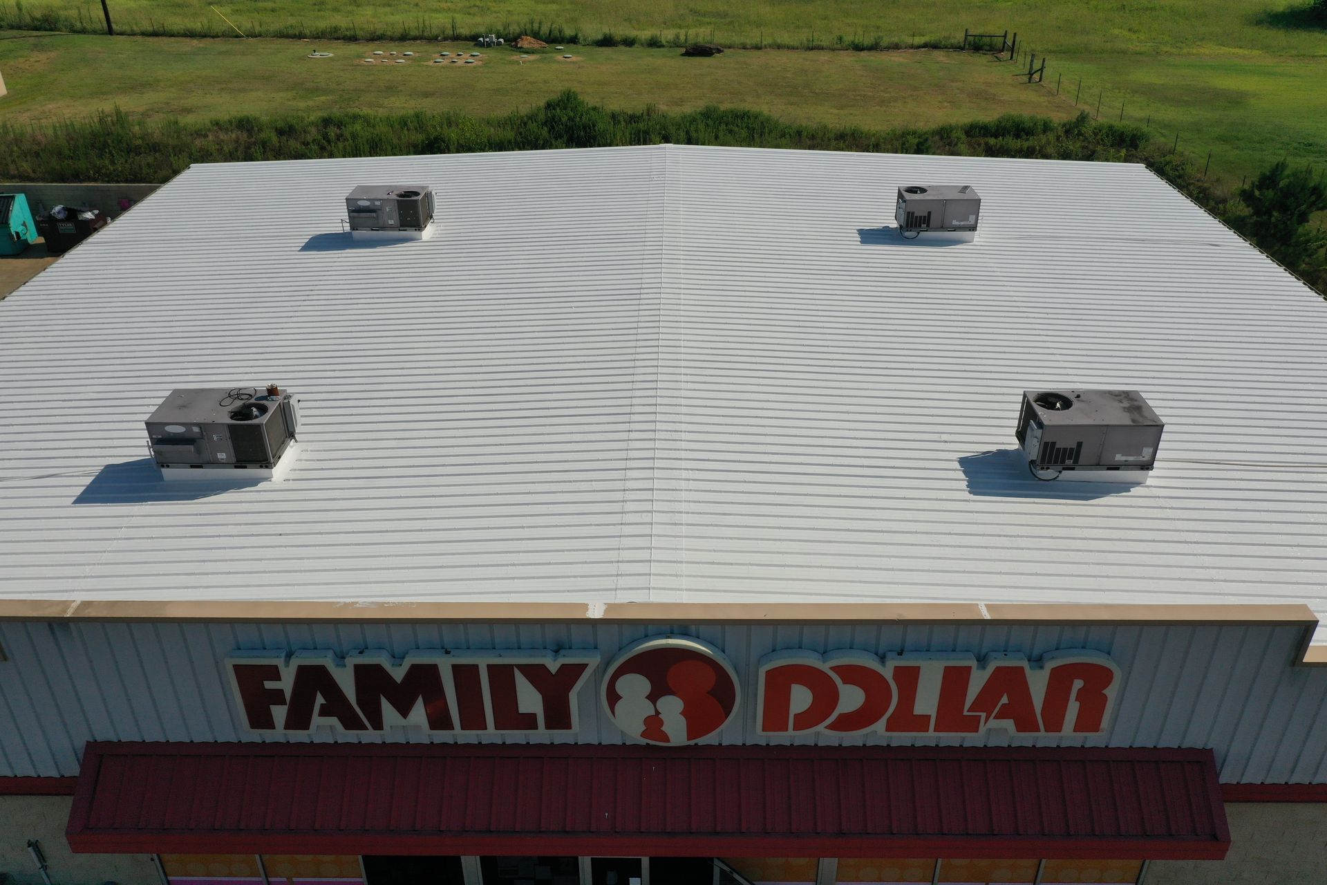 Aerial view of a Family Dollar store roof with four HVAC units and circular heat patterns.