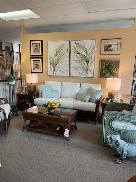 Cozy living room with white sofa, coffee table, framed art, and soft lamps on beige walls.