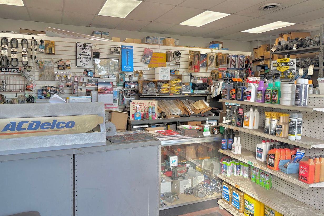 Interior of an auto parts store with shelves stocked with various automotive products. ACDelco sign visible.