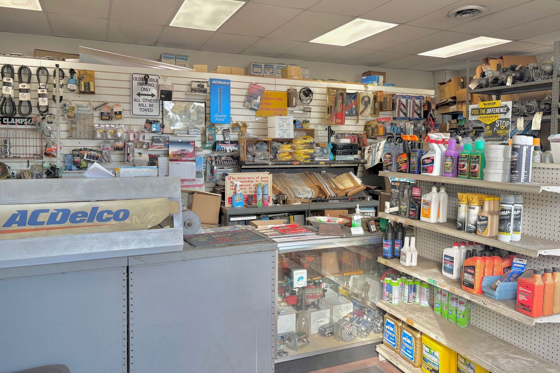 Interior of an auto parts store with shelves stocked with various automotive products. ACDelco sign visible.