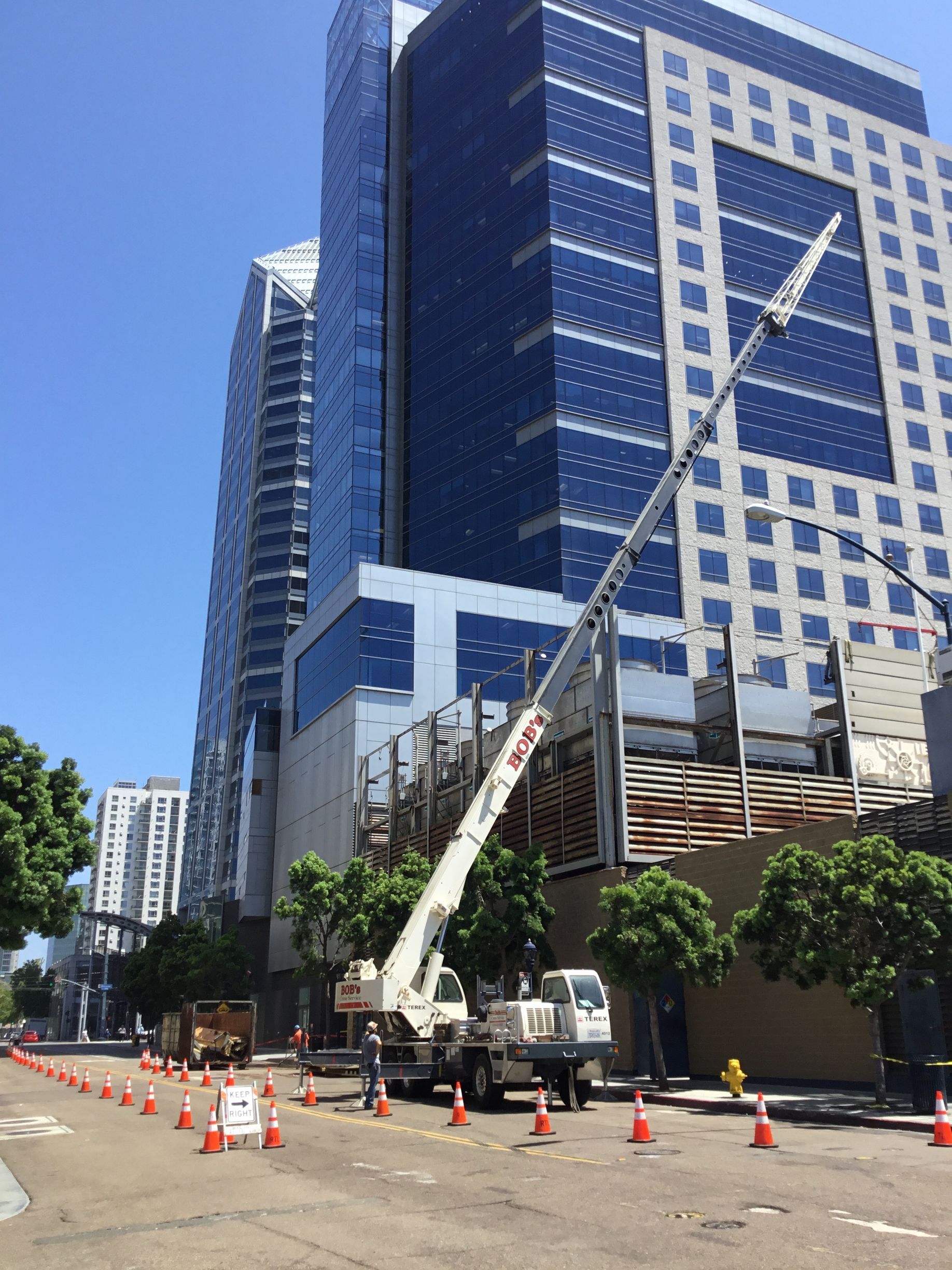A large building with a crane in front of it.