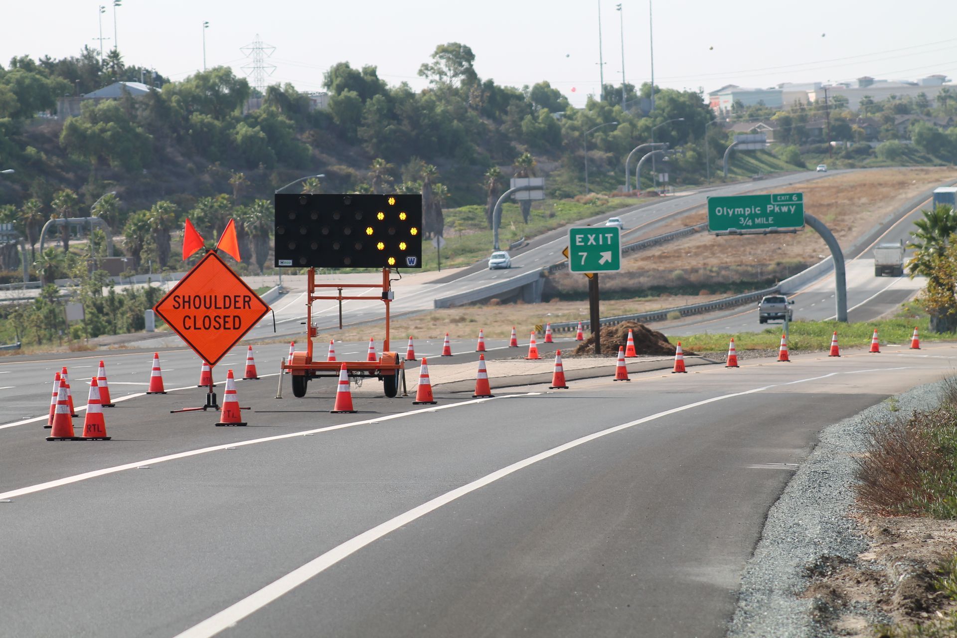 A sign on the side of a highway that says closed.