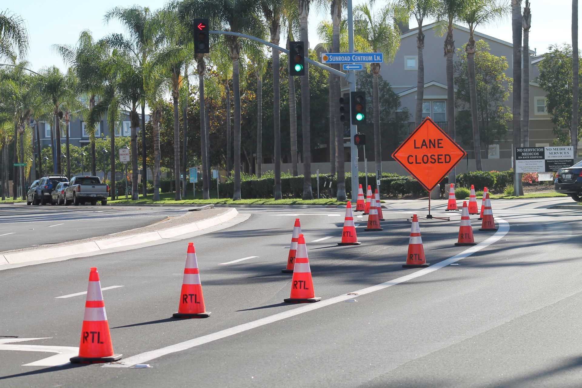 A lane is closed sign is on the side of the road.