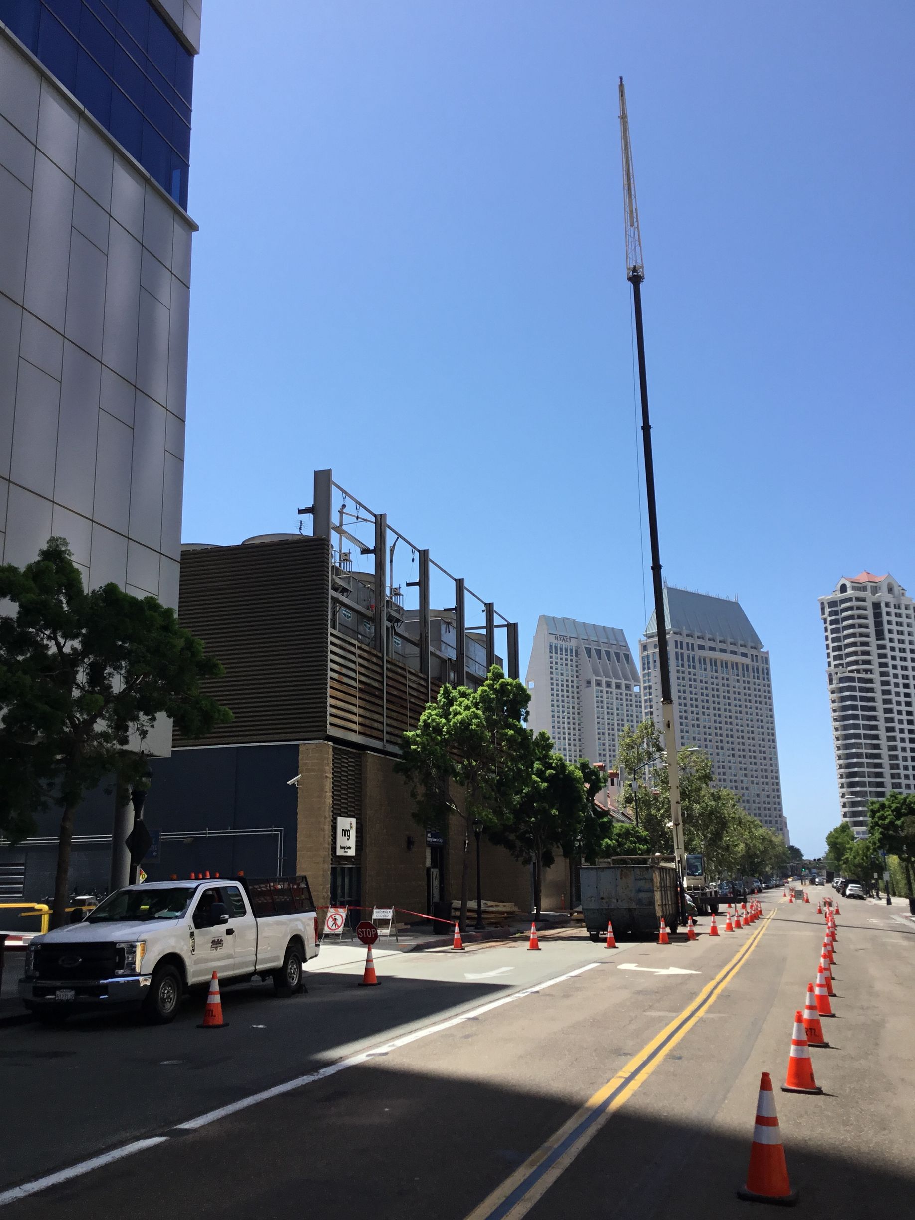 A white truck is parked on the side of the road.