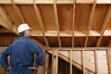 Worker inspect house foundation made of wood