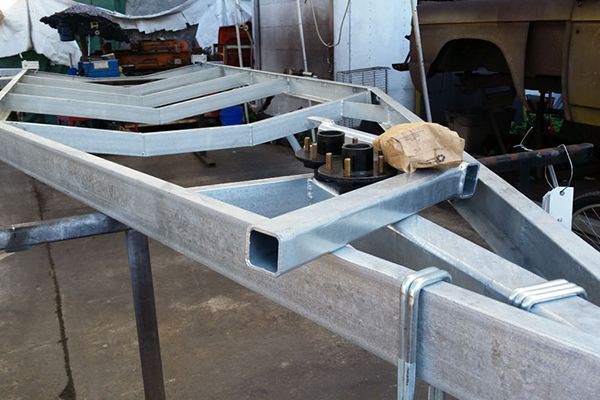 A metal frame is sitting on a table in a garage