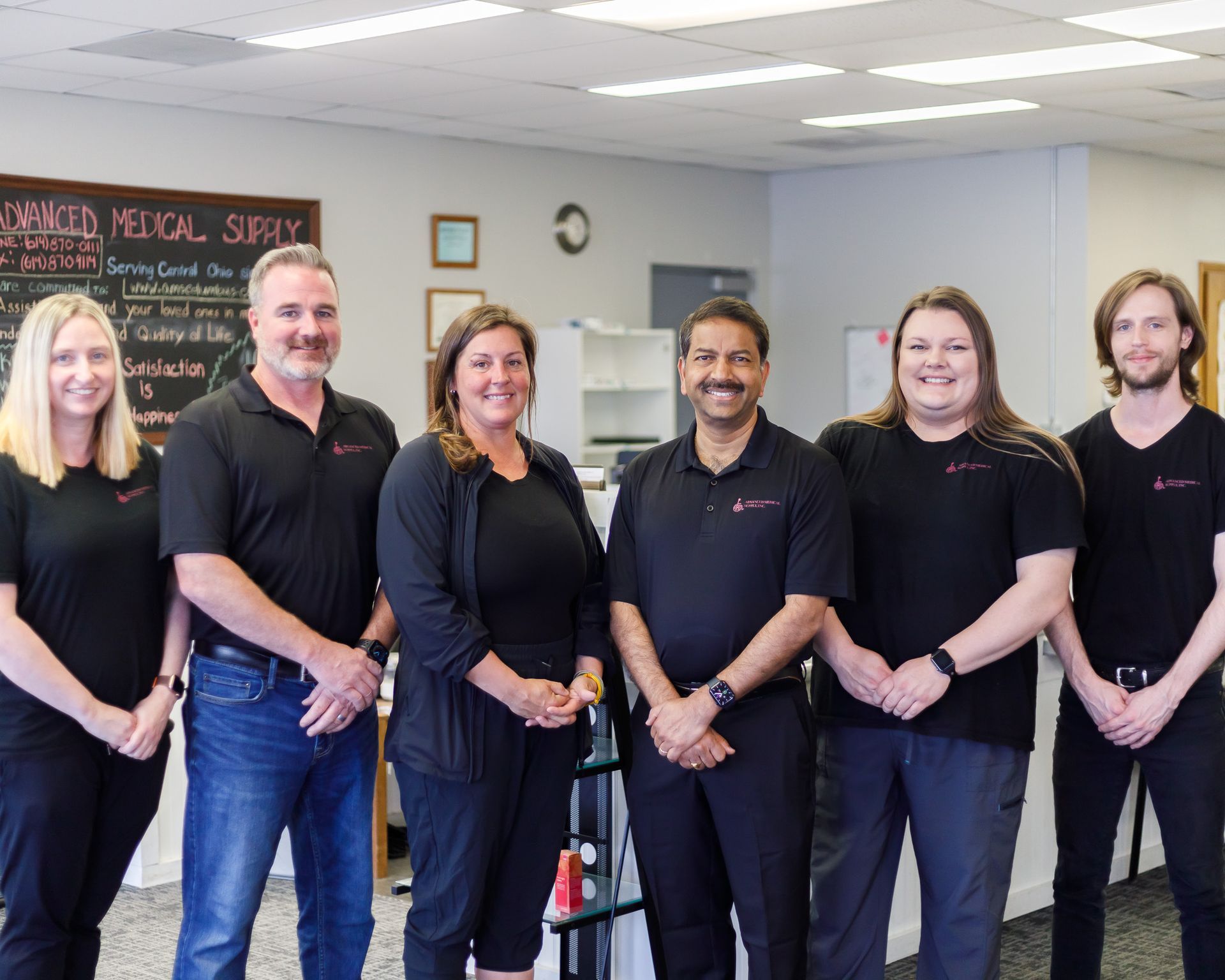 A group of people standing next to each other in a room.