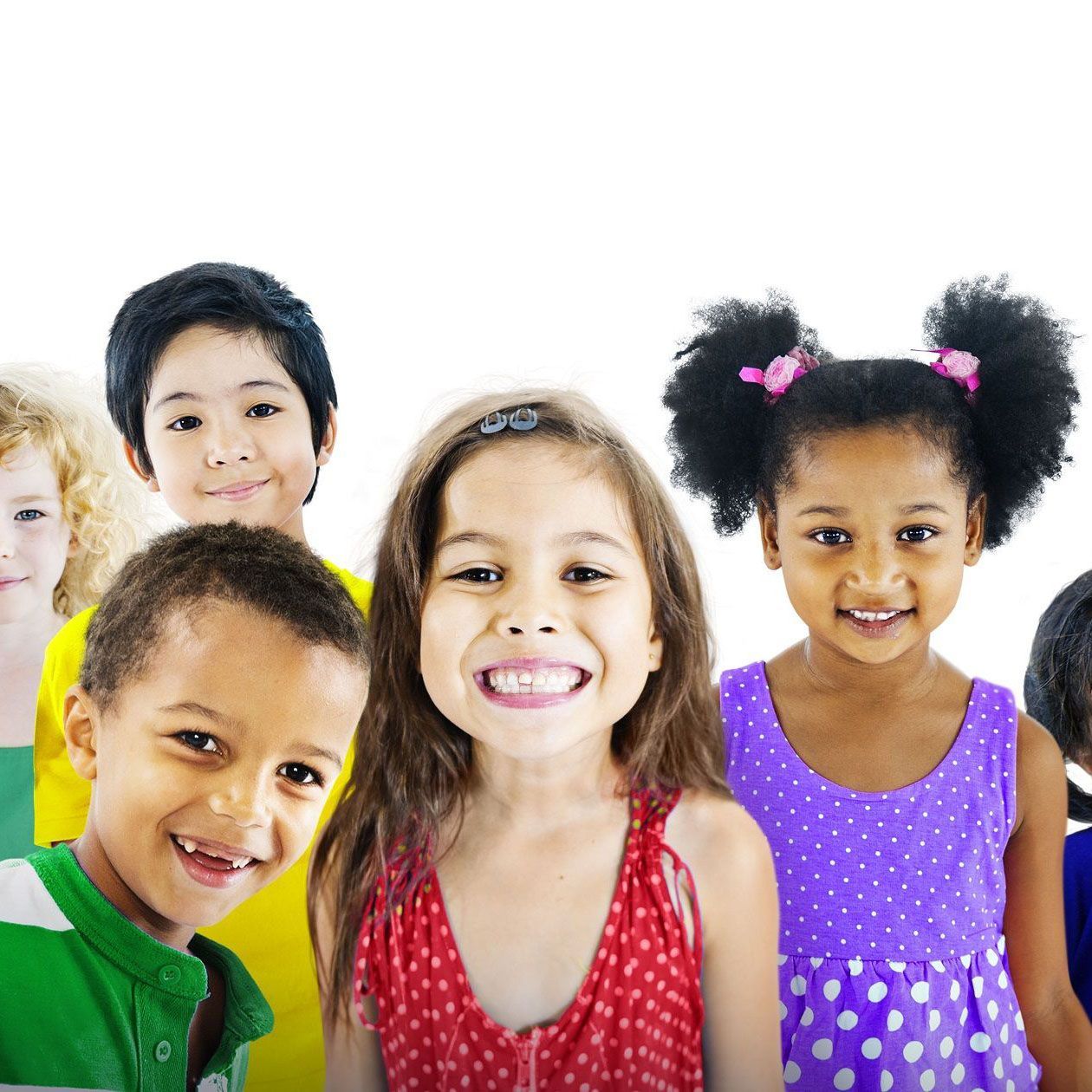 Group of diverse, smiling children in bright clothing against a white background.