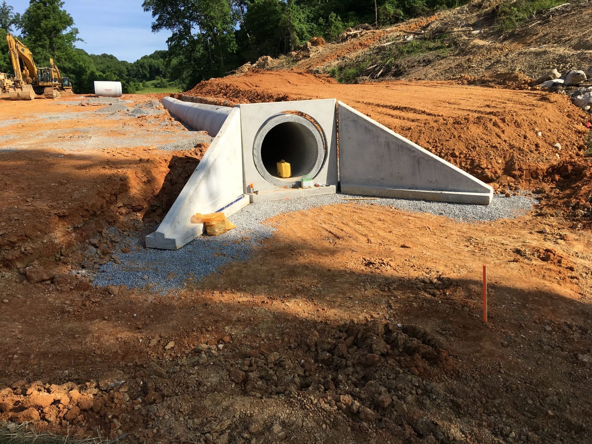 A construction site with a large pipe in the middle of it