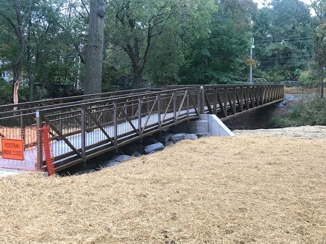 A wooden bridge is being built over a river