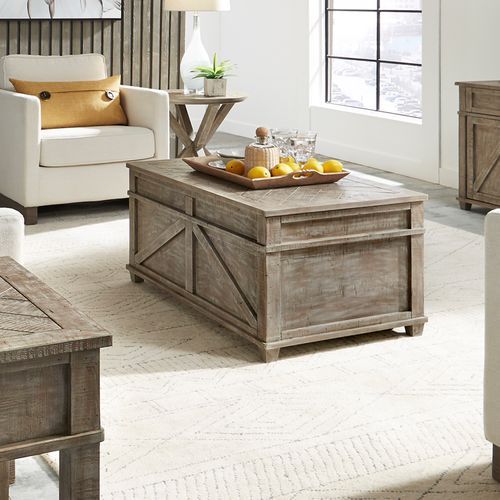 A living room with a wooden coffee table and a tray of lemons on it