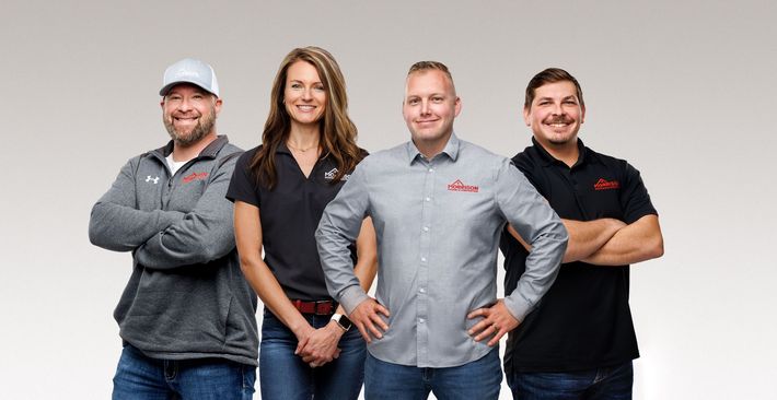 A group of people standing next to each other in front of a morrison roofing and solar logo.