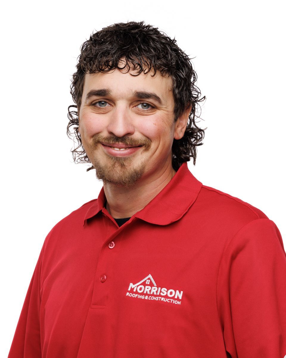 A man wearing a red shirt that says morrison on it