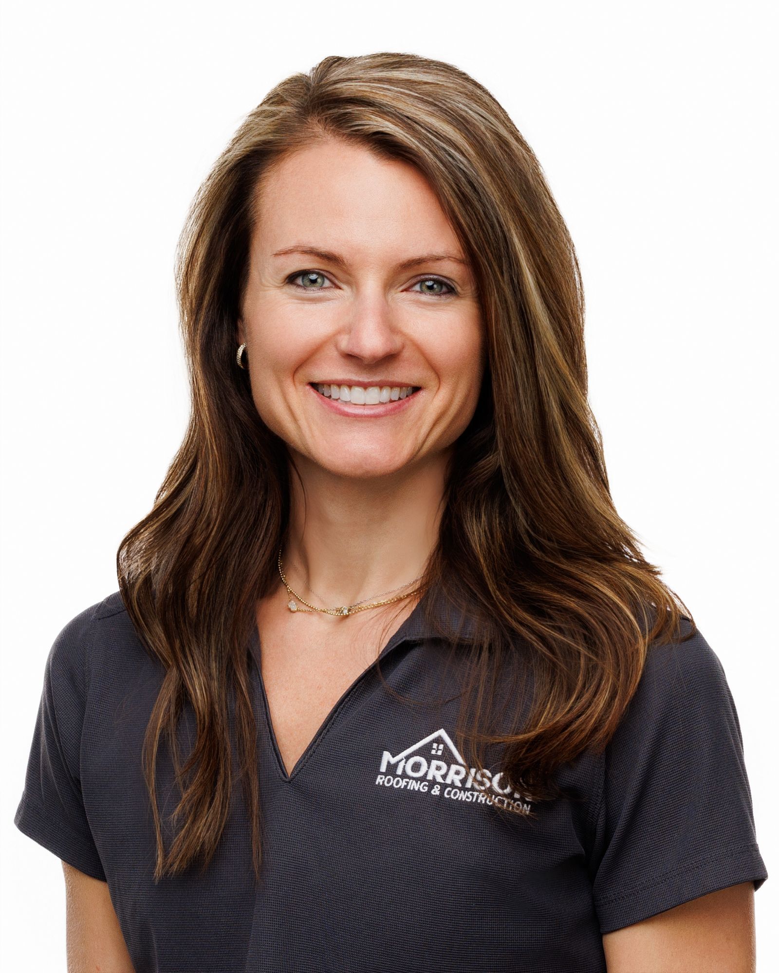 A woman wearing a morris shirt is smiling for the camera.