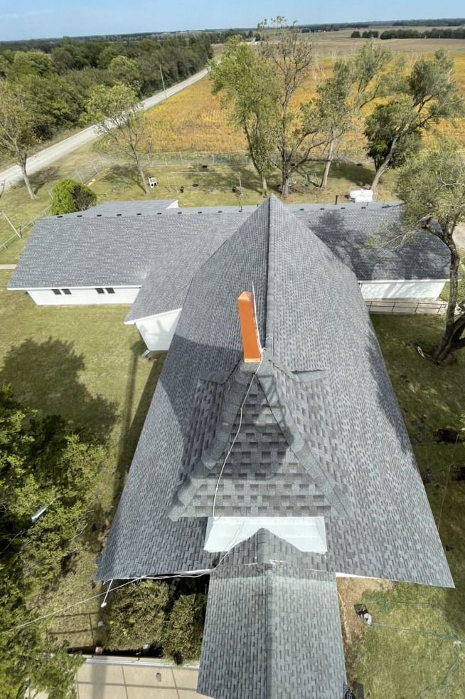 An aerial view of a house with a chimney on the roof.
