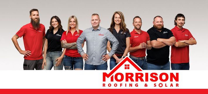 A group of people standing next to each other in front of a morrison roofing and solar logo.