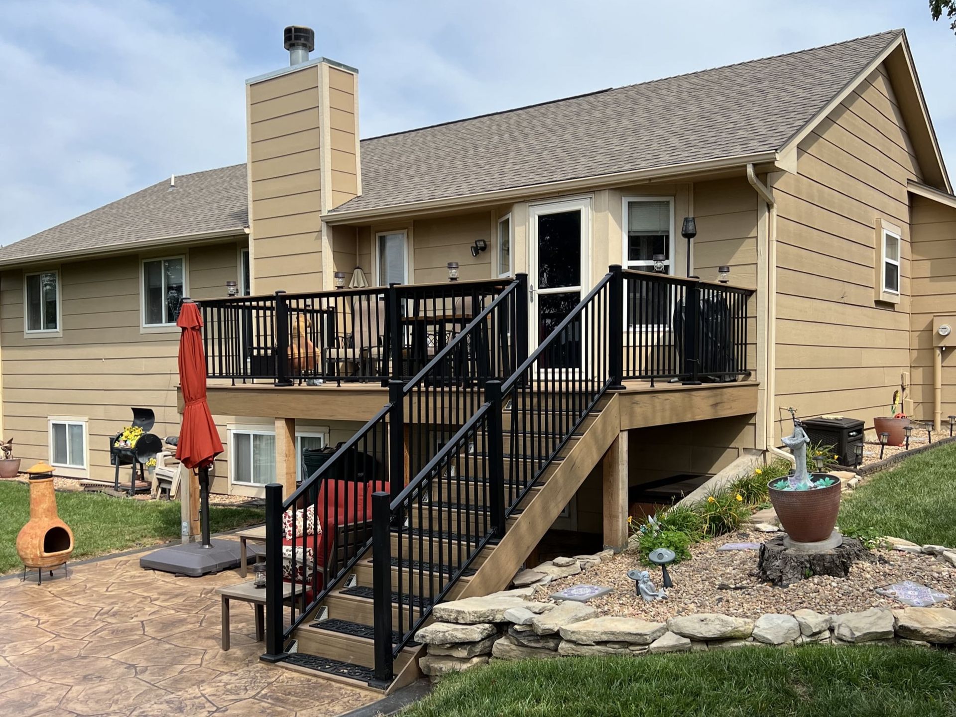 A house with a deck and stairs leading up to it.