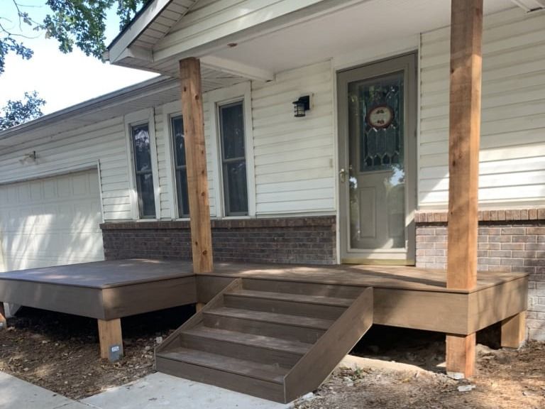 A white house with a porch and stairs