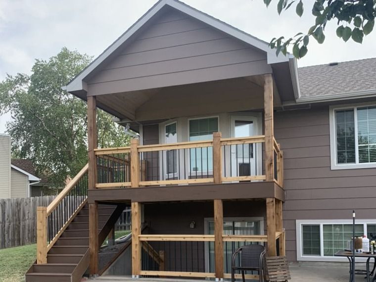 The back of a house with a deck and stairs.