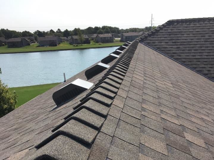The roof of a house with a lake in the background
