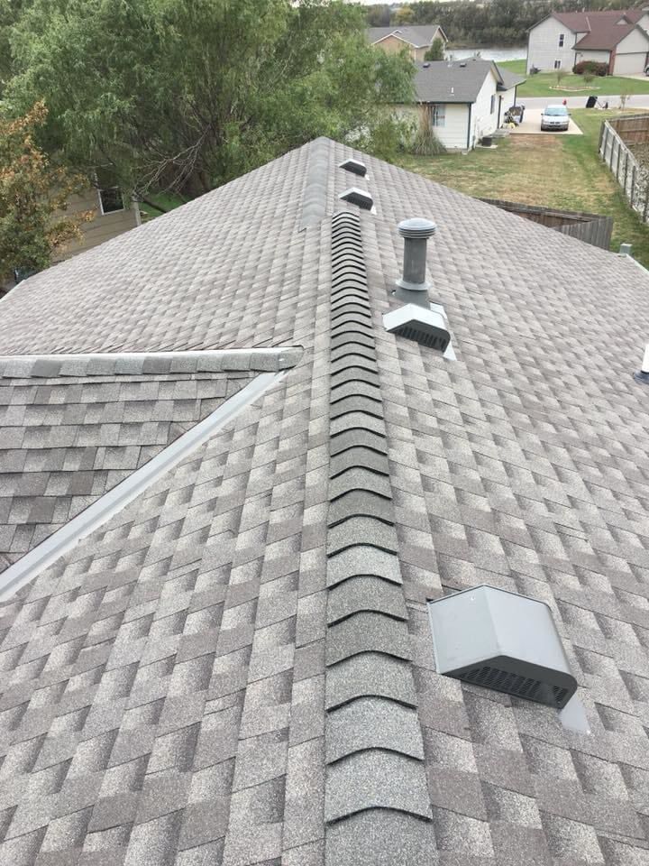 A close up of a roof with a chimney on it.