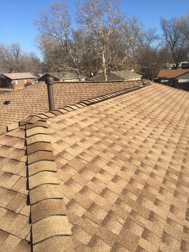 A close up of a roof with a chimney on top of it.