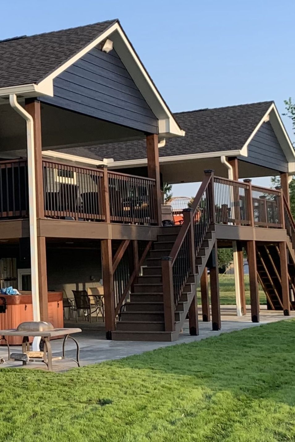 A house with a large deck and stairs leading up to it.