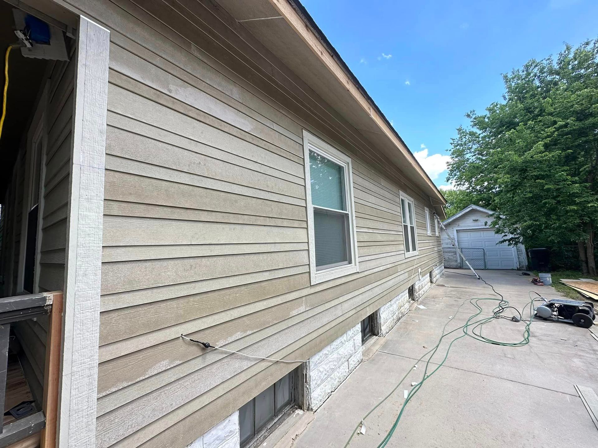 A house with a lot of windows is being painted.