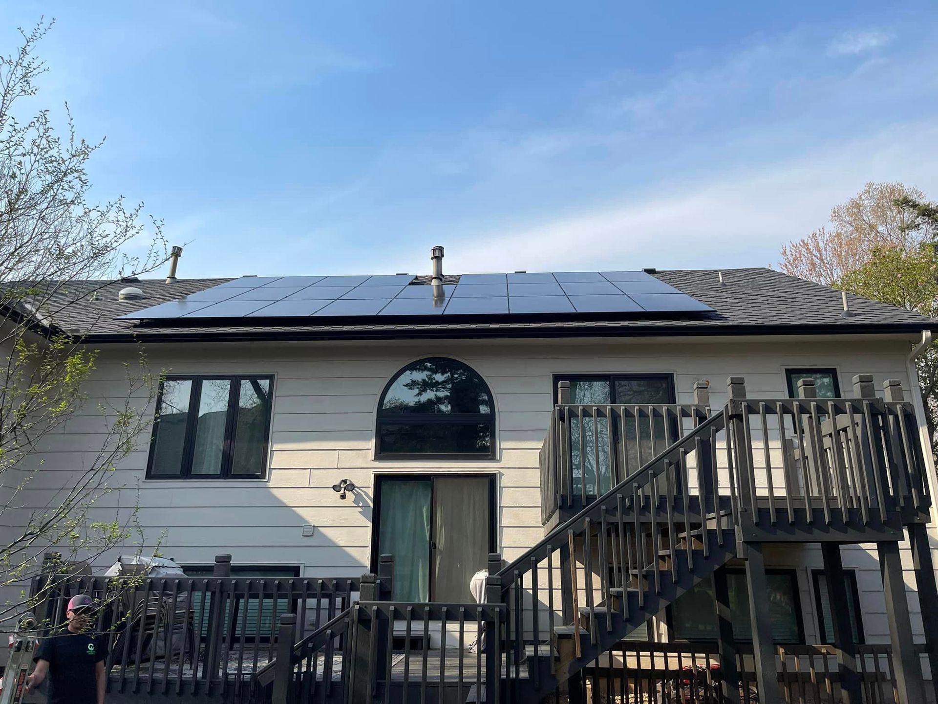 The back of a house with solar panels on the roof.