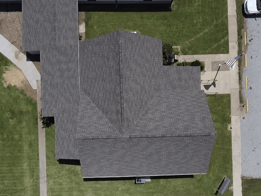 An aerial view of a house with a gray roof.