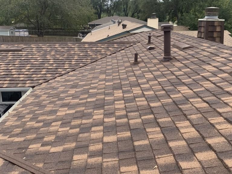 A close up of a roof with a chimney on it.