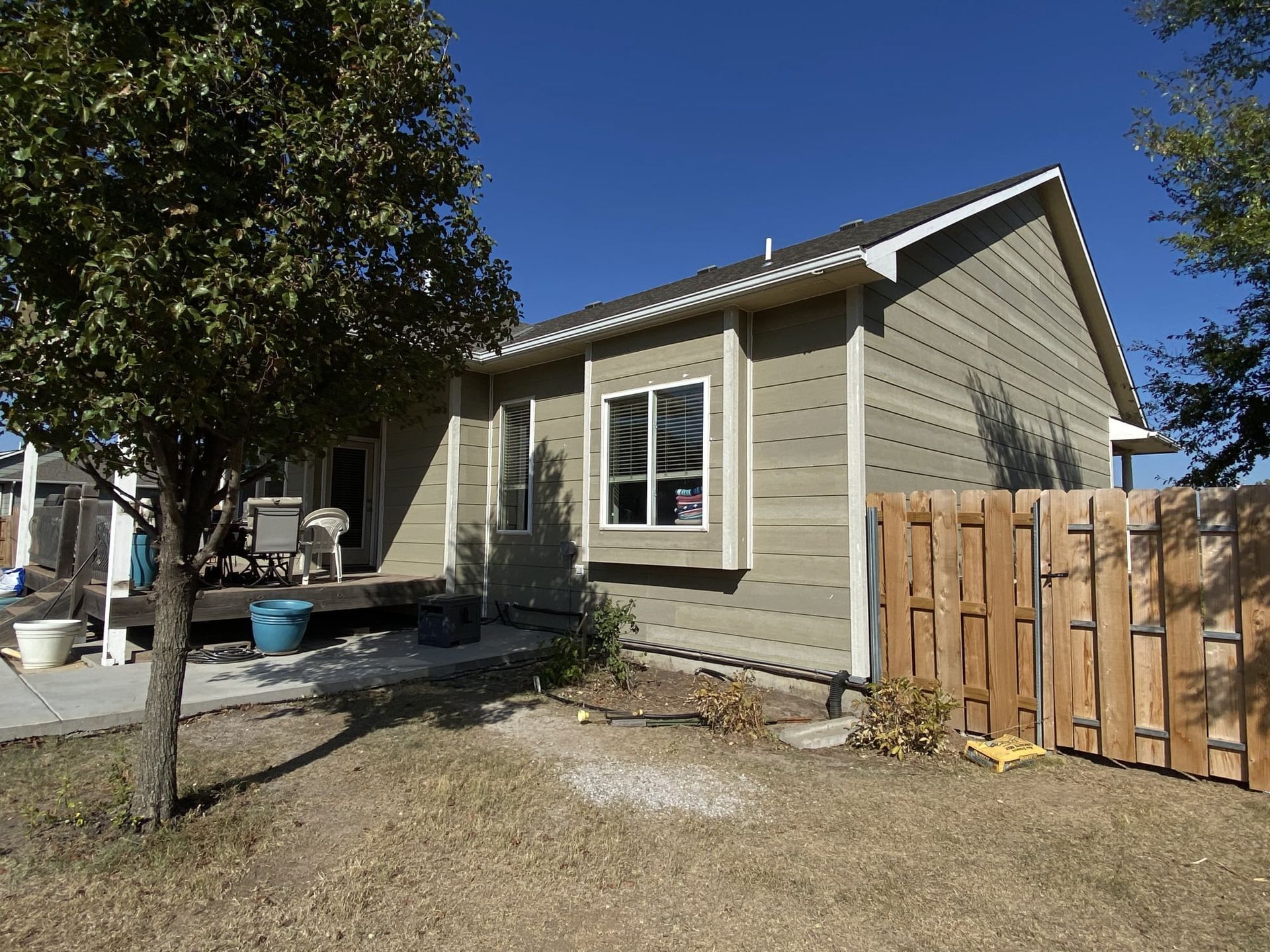 A small house with a wooden fence in front of it