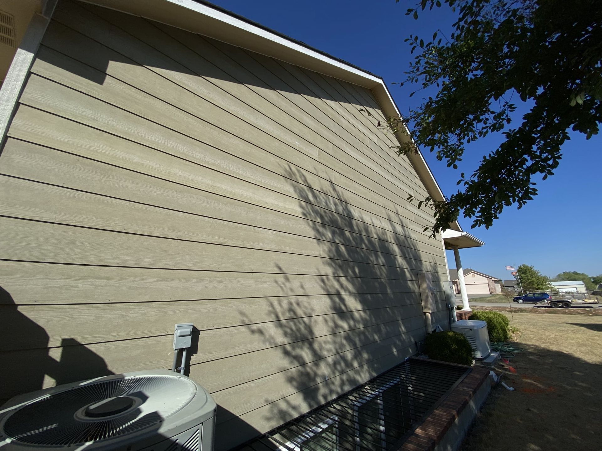 A house with a air conditioner on the side of it