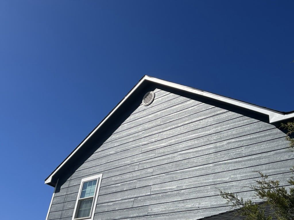 Looking up at a house with a blue sky in the background