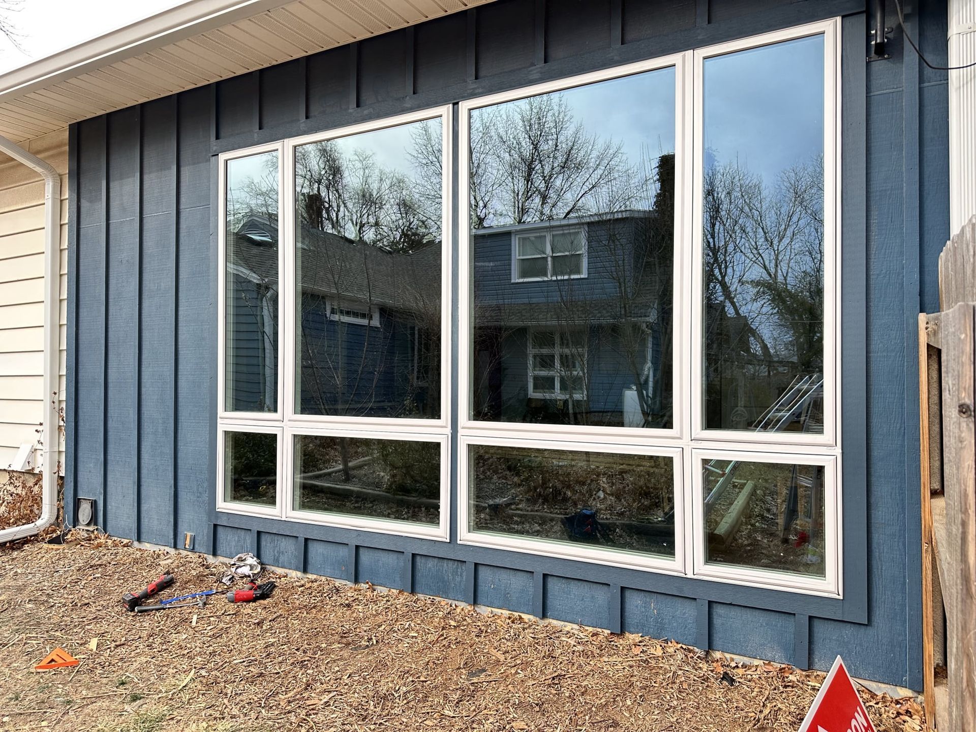 A house with a lot of windows on the side of it.