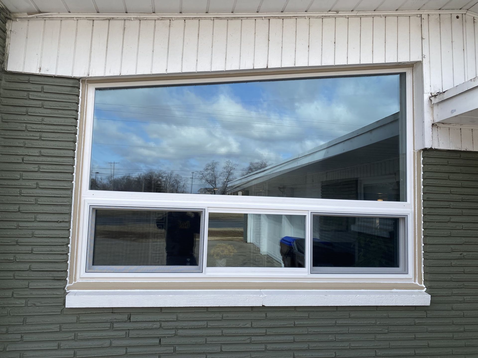A large window on the side of a brick building