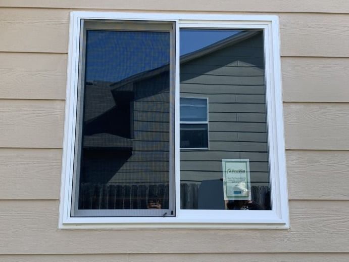 A sliding glass window on the side of a house