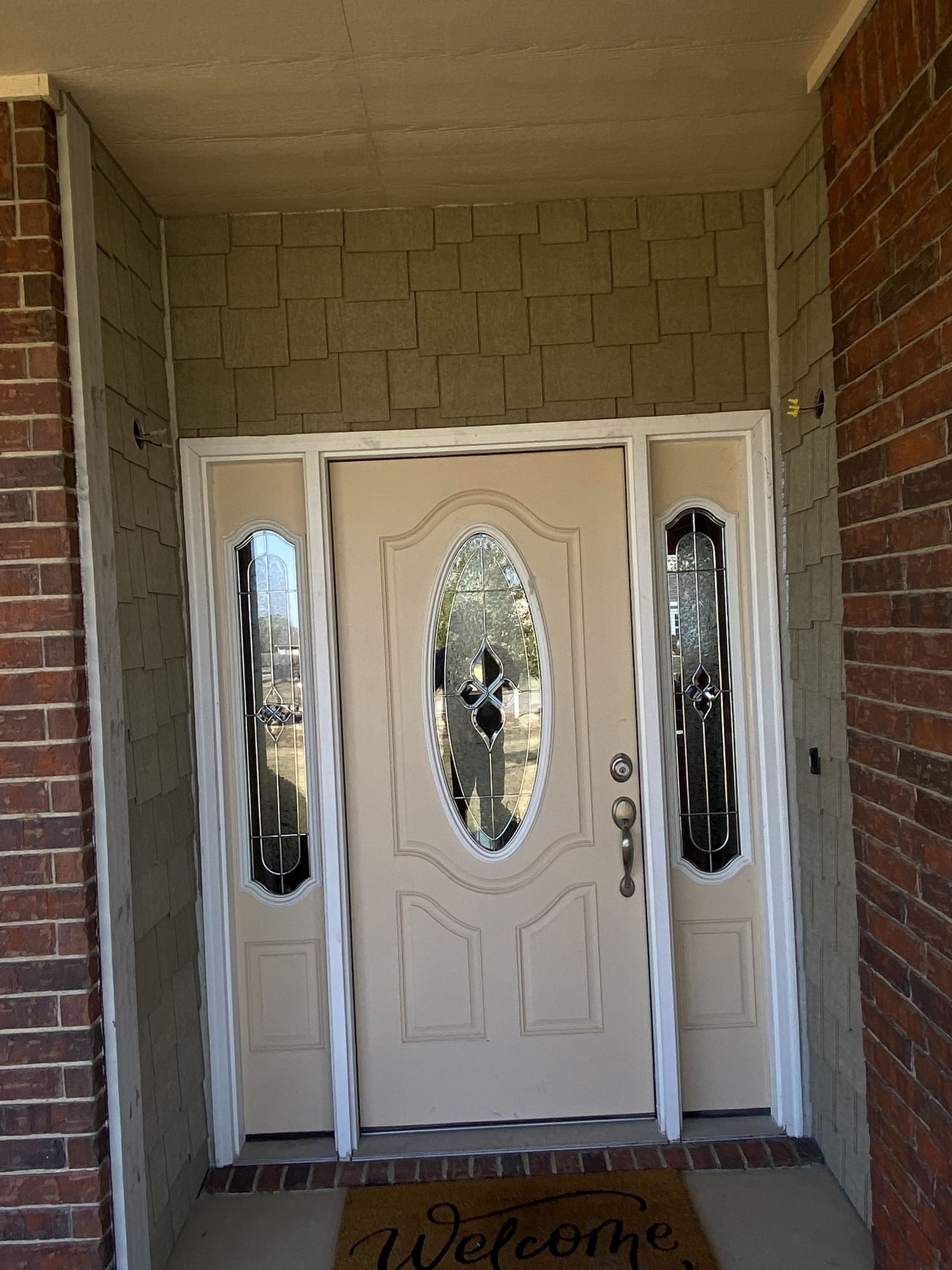 A door with a welcome mat in front of it