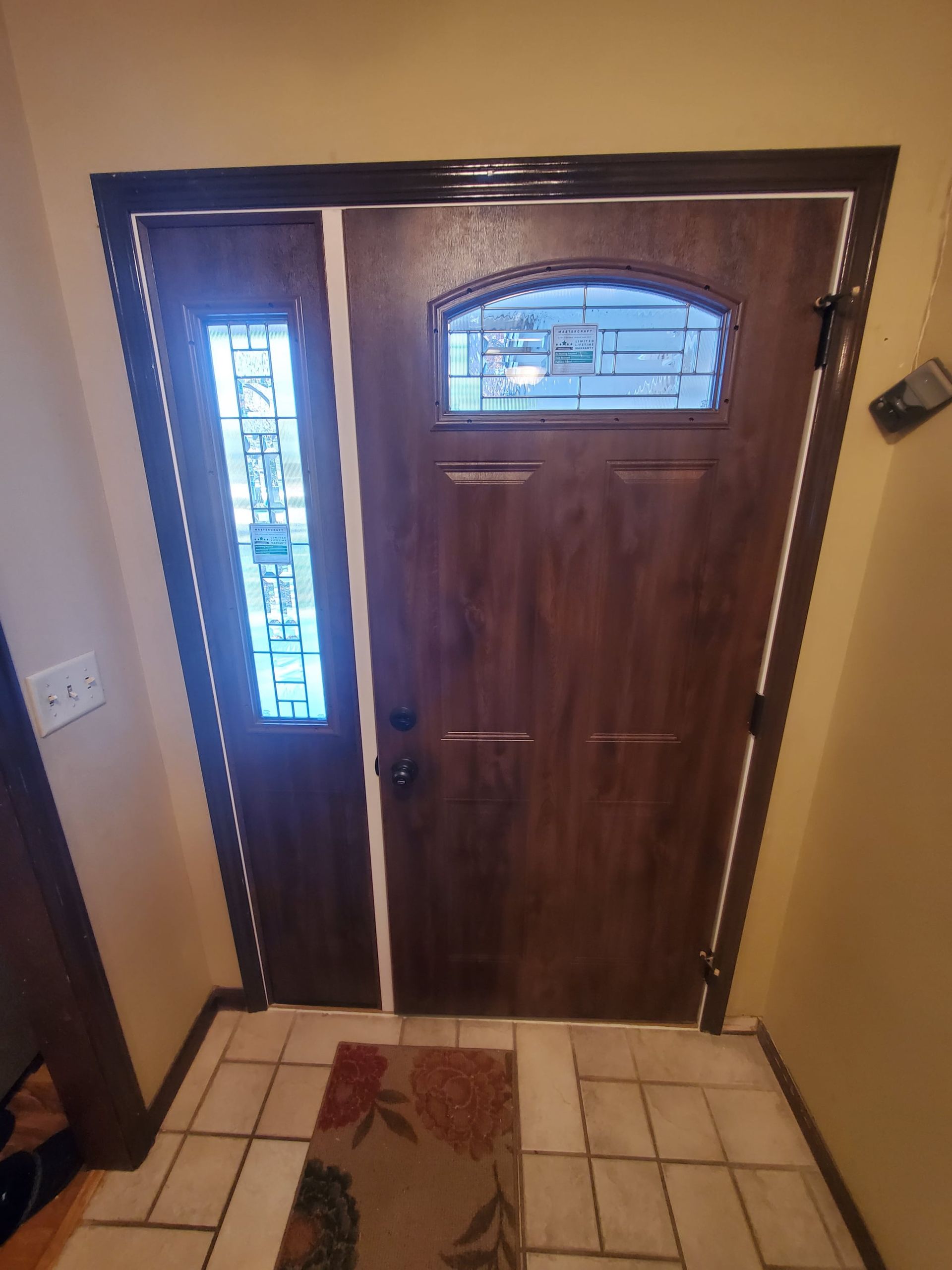 A wooden door with a stained glass window in a hallway