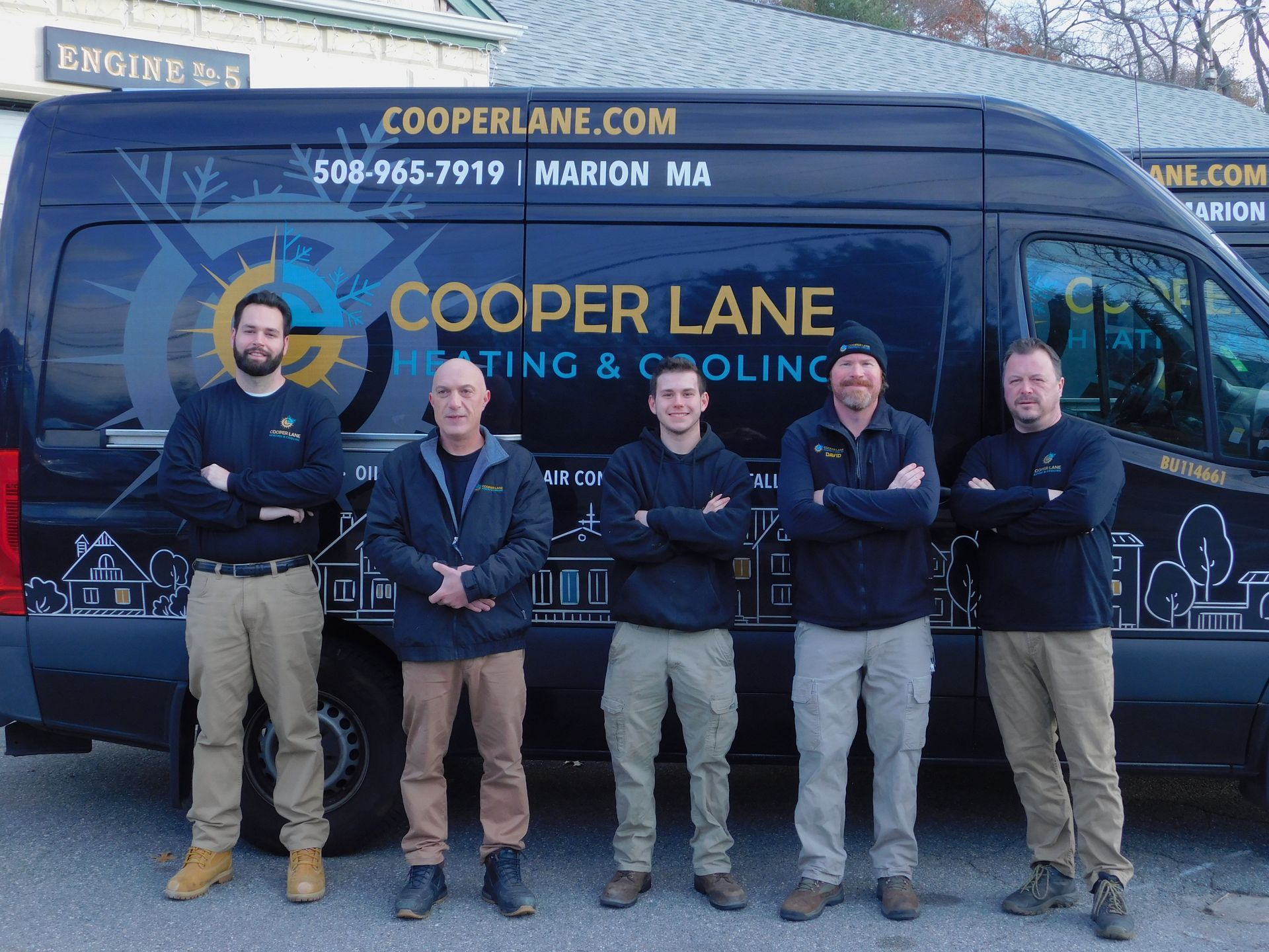 Five men in front of a black van with Cooper Lane Heating & Cooling logo.