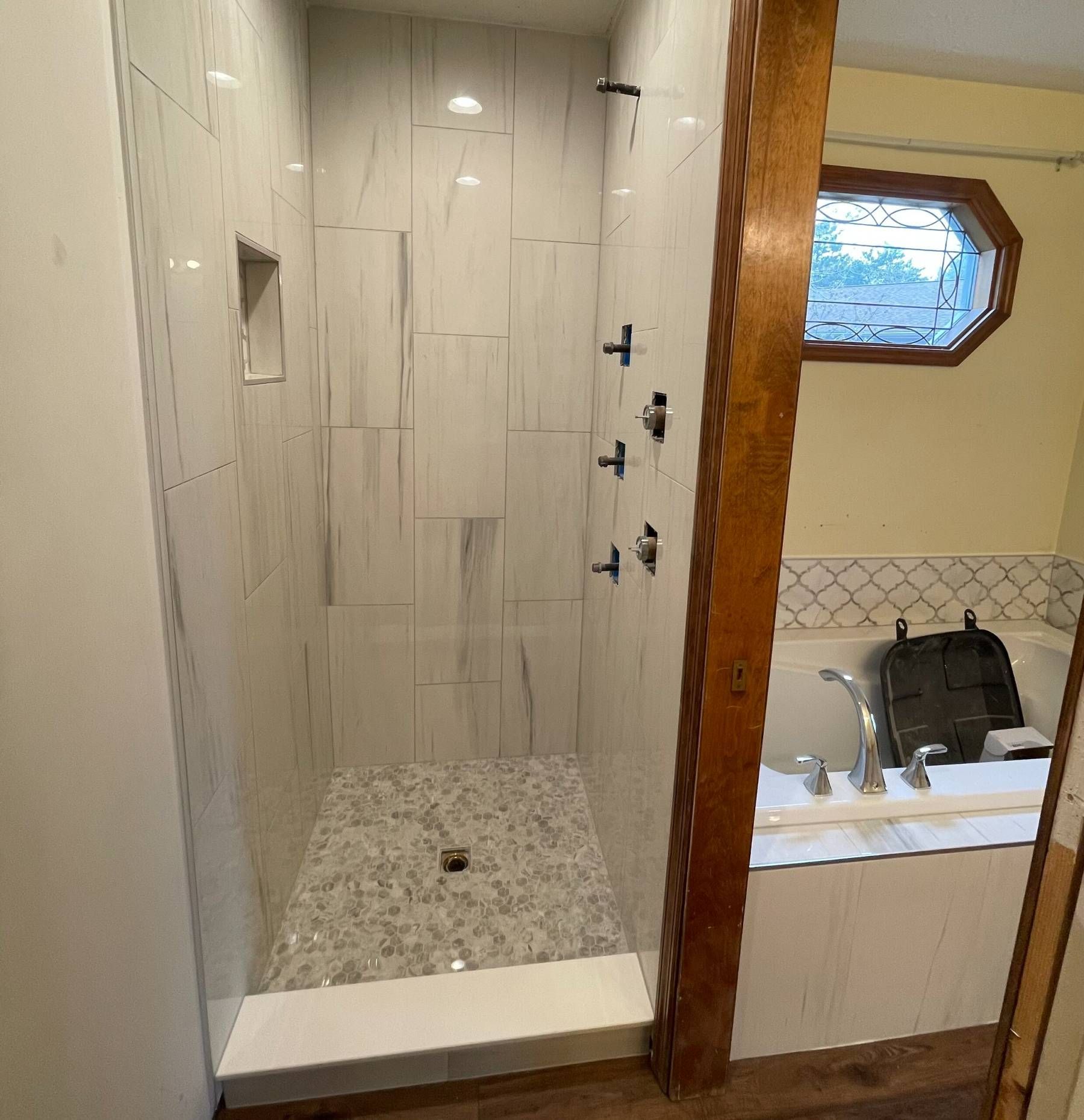 A bathroom with a walk in shower and a bathtub