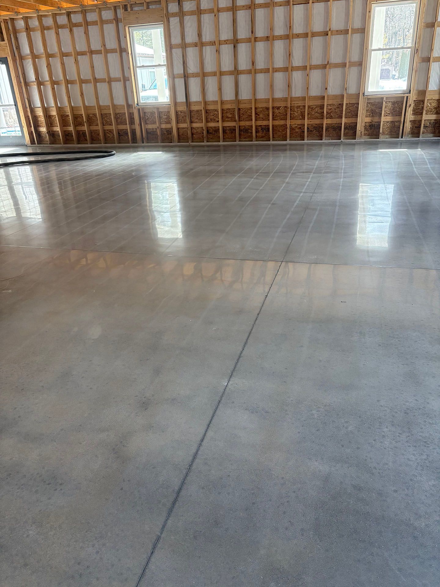 A large room with a concrete floor and wooden walls.