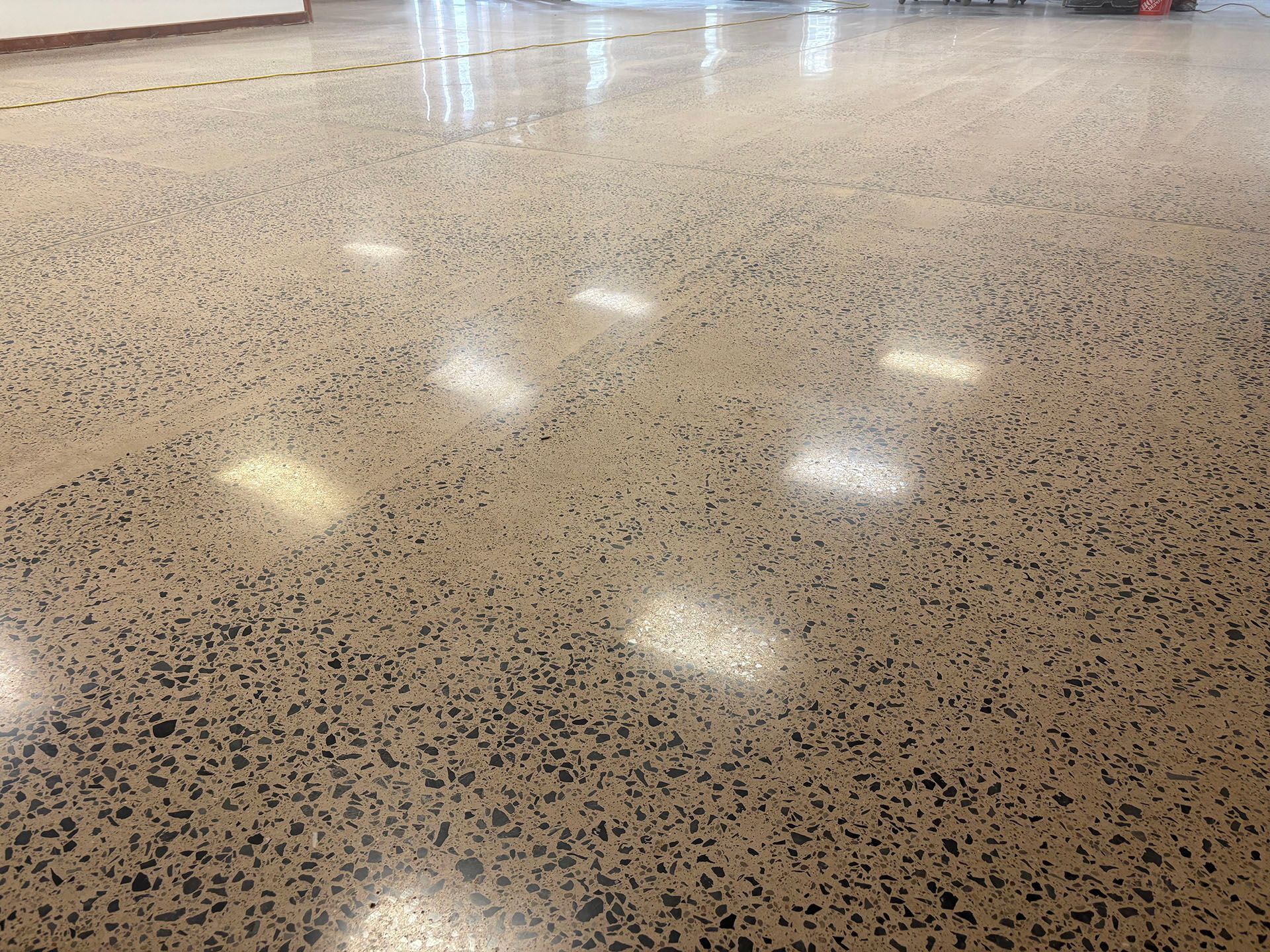 A shiny concrete floor with a lot of small dots on it