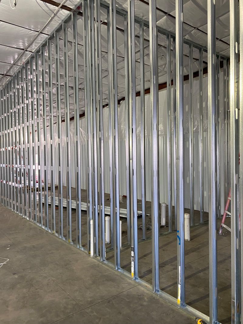 A large room with a lot of metal frames on the wall.